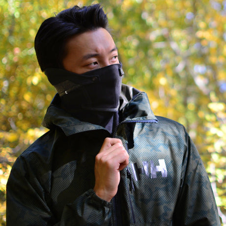 Stylish black winter face mask (The Commuter by Emberhurst) with anti fog air vents worn by a young man.